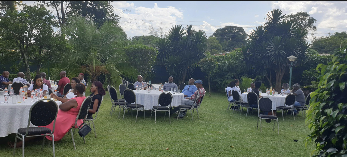 Birthday guests seated at tables in the garden