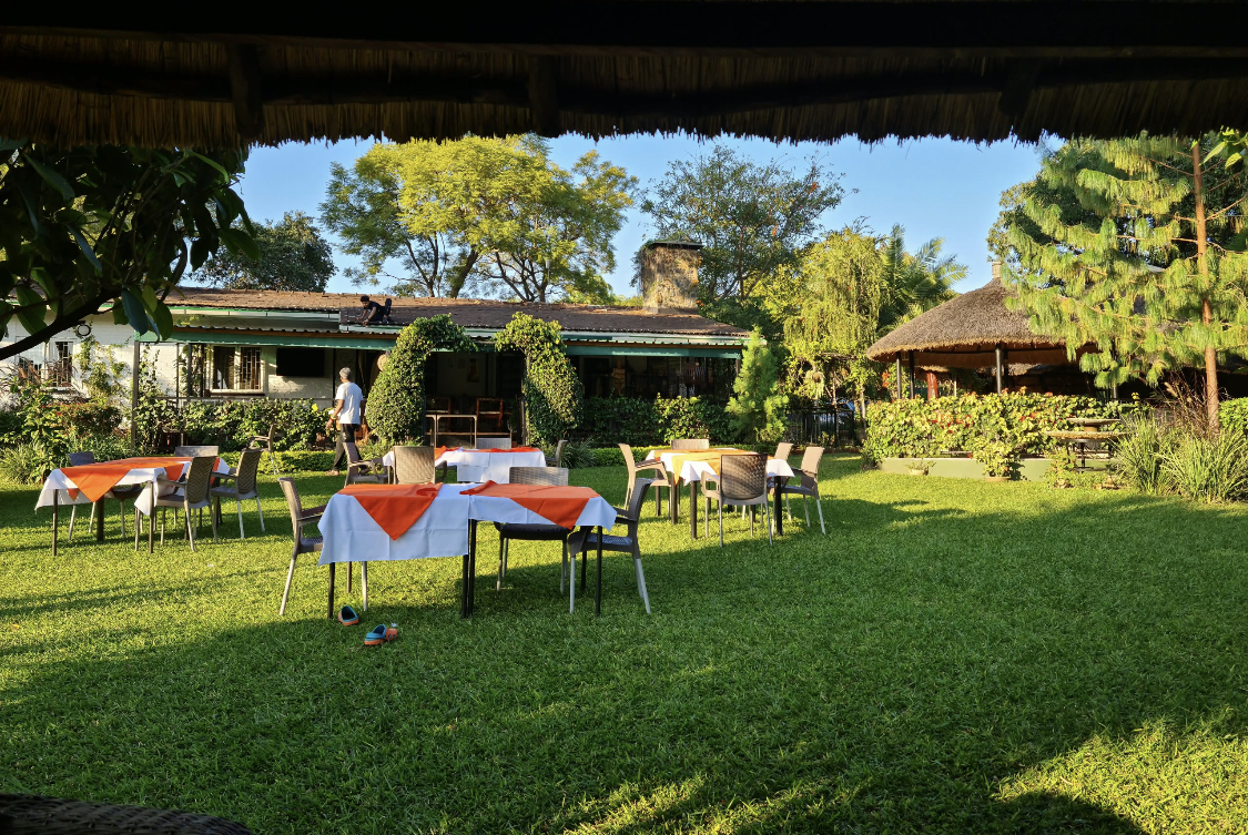 Garden venue prepared with tables for a celebration