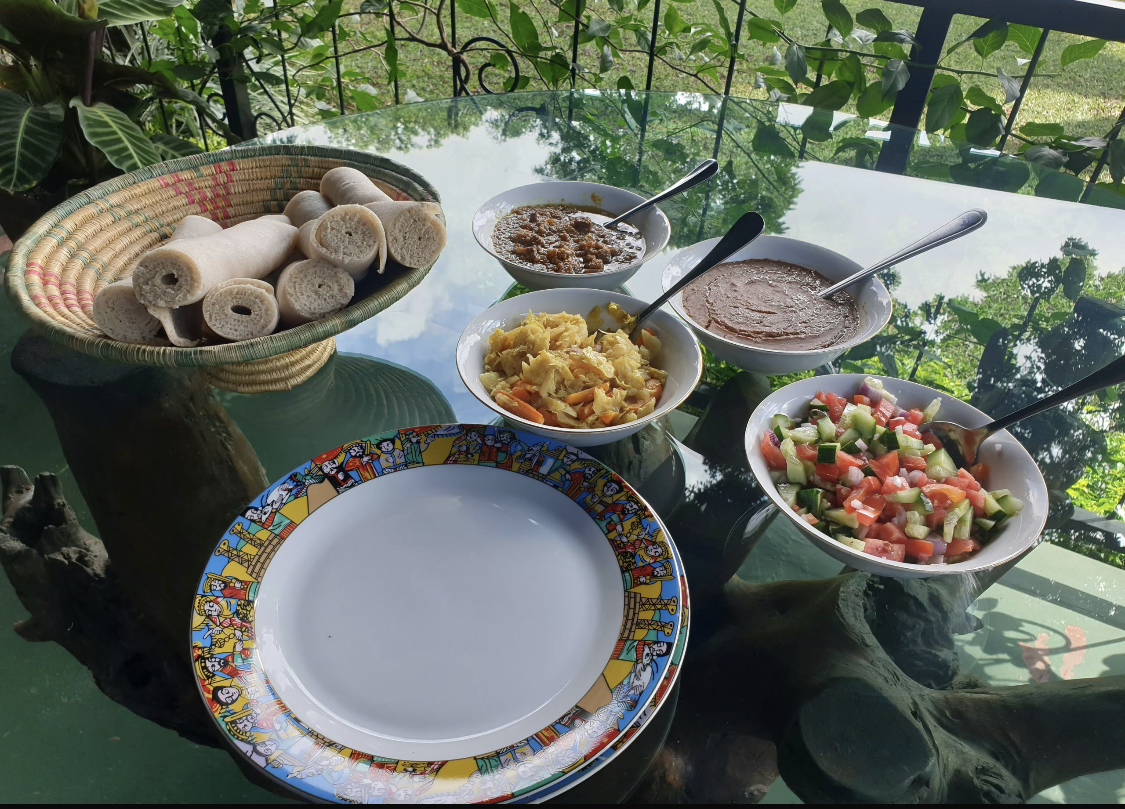 Injera basket surrounded by Ethiopian stews and salad